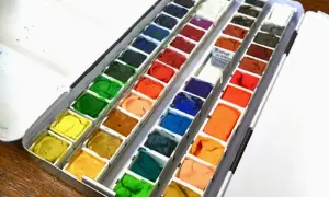 Paleta farb akwarelowych, w tym odcień "Burnt Sienna". To świetny zestaw do malowania, który pokazuje, co to jest gwasz.