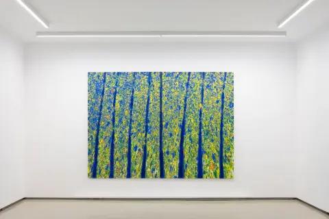Abstrakcyjne obrazy Leona Tarasewicza w galerii. Intensywny błękit i żółć tworzą dynamiczną kompozycję, przypominającą rozkwitającą naturę.