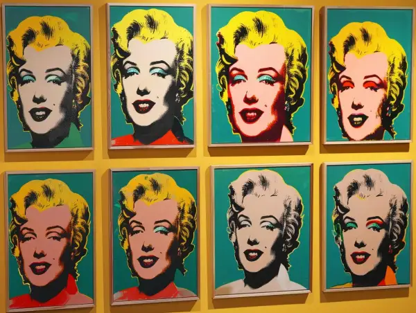 Osiem portretów Marilyn Monroe w stylu pop art Warhol, z różnymi kolorami tła i makijażu.